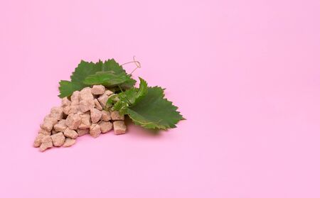 Creative The sugar content of grapes. Bunch of grapes made of sugar on a pink background. Mock upの写真素材