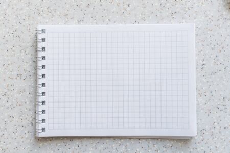 white notebook in a cage on a spiral close-upの写真素材