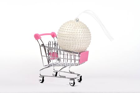 White snow ball in shopping cart isolated on white backgroundの写真素材