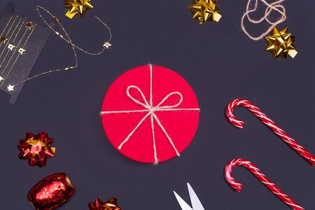 Red round gift box on black background, new year and Christmas gift wrapping . top viewの写真素材