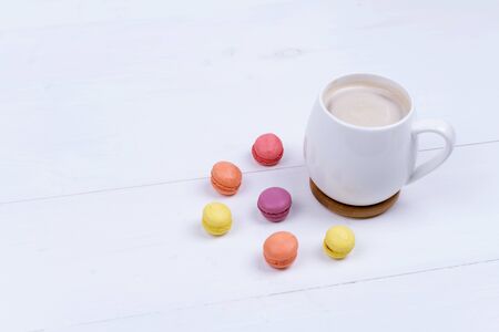 White Cup of fragrant cappuccino with macaroni cakes on white background, top viewの写真素材