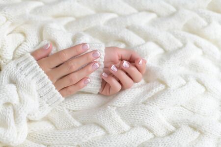 Woman's hand with French manicure isolated on white backgroundの写真素材