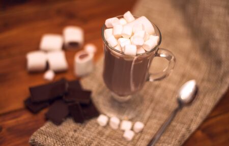 Cacao drink in a glass with marshmallow on the background of bokeh lights, Hot Christmas drinkの写真素材