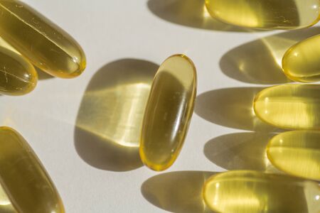Close up capsules of fish fat oil , omega 3, vitamin Healthy food diet. Nutritional supplementの写真素材