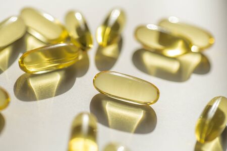 Close up capsules of fish fat oil , omega 3, vitamin Healthy food diet. Nutritional supplementの写真素材