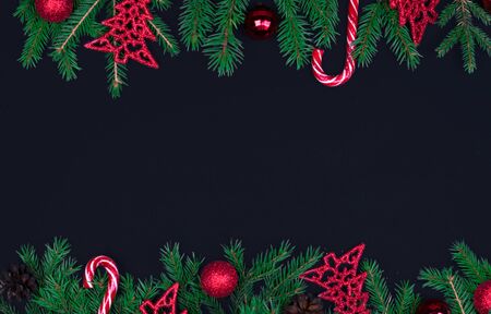 Spruce branches, Christmas balls, candy on a black background, preparing for the New year and Christmas, top view Flat layの写真素材
