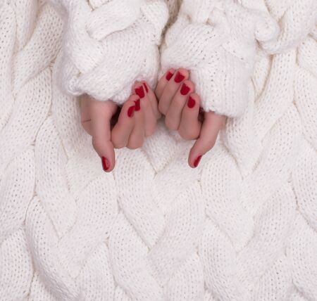 Woman's hand with red manicure isolated on white backgroundの写真素材