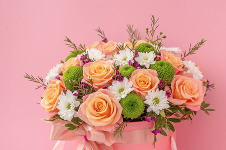 Beautiful bouquet in a pink luxury present box, isolated on pink backgroundの写真素材