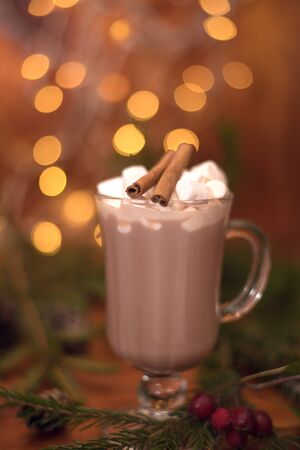 sweet cocoa in a glass with marshmallow on the background of bokeh lights, Christmas drink. Christmas decoration and bokeh of light in backgroundの写真素材