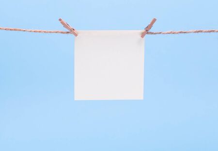 sheet of paper for notes hanging clothespins, copy spaceの写真素材
