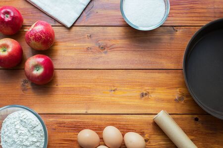 Baking concept background. Border design cooking,Christmas and winter cookies ingredients.Baking pastry and cookies: apples, spices, sugar, eggs on woodの写真素材