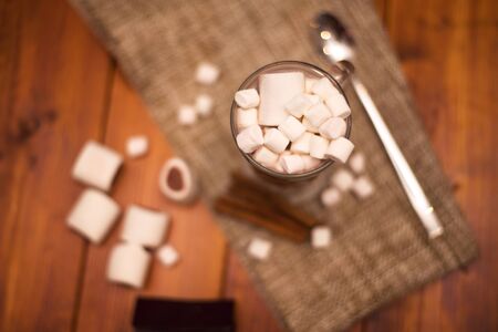 Cacao drink in a glass with marshmallow on the background of bokeh lights, Christmas drinkの写真素材