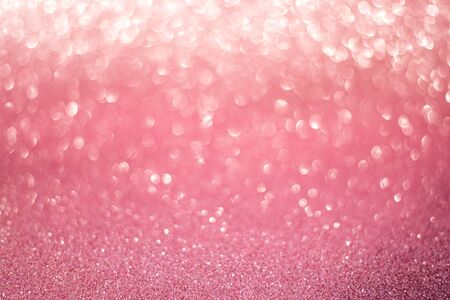 beautiful pink gold sequins on the glitter sparkle of sun light background with blur bright bokehの写真素材