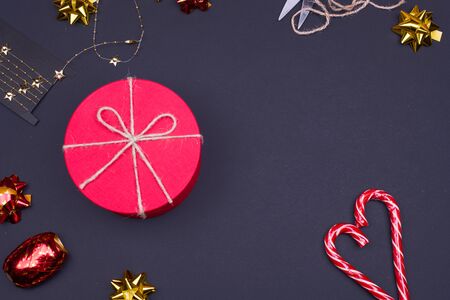 Red round gift box on black background, new year and Christmas gift wrappingの写真素材