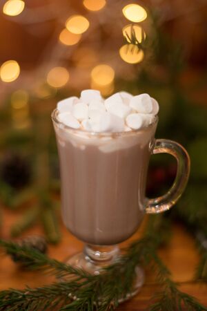 sweet cocoa in a glass with marshmallow on the background of bokeh lights, Christmas drink. Christmas decoration and bokeh of light in backgroundの写真素材