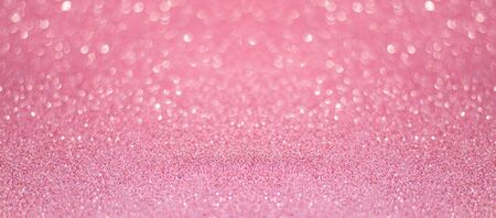 beautiful pink sequins on the glitter sparkle of sun light background with blur bright bokehの写真素材
