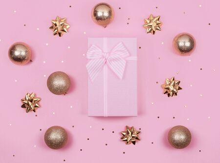 pink gift or present boxes and gold Christmas decorations on pink background top view. Flat lay.の写真素材