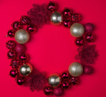 Red and gold Christmas balls on red background, top view , copy space, flat layの写真素材