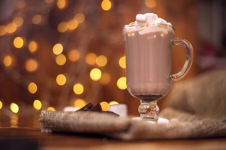 sweet cocoa in a glass with marshmallow on the background of bokeh lights, Christmas drink. Christmas decoration and bokeh of light in backgroundの写真素材