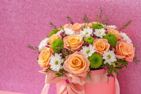 Beautiful bouquet in a pink luxury present box, isolated on pink backgroundの写真素材