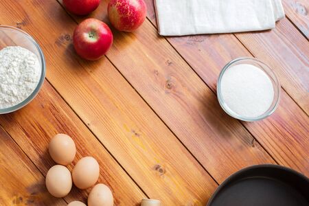 Baking concept background. Border design cooking,Christmas and winter cookies ingredients.Baking pastry and cookies: apples, spices, sugar, eggs on woodの写真素材