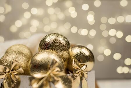 golden christmas ball on golden star bokeh backgroundの写真素材