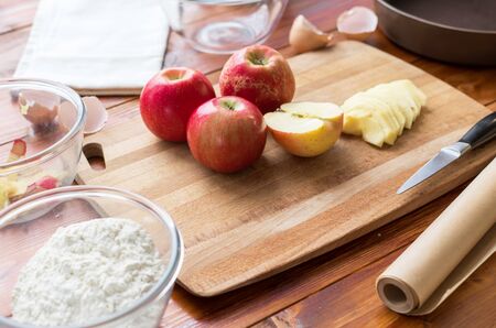 Baking concept background. Border design cooking,Christmas and winter cookies ingredients.Baking pastry and cookies: apples, spices, sugar, eggs on woodの写真素材