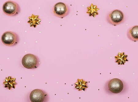 gold Christmas ball and stars decorations on pink background top view. Flat lay. Mock upの写真素材