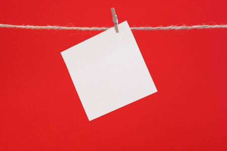 sheet of paper for notes hanging clothespins, copy spaceの写真素材