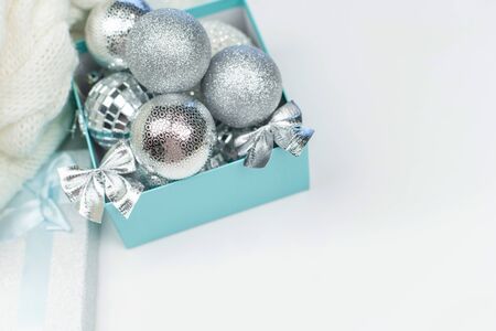Blue box with silver Christmas balls on the white background, mock up, copy space, flat lay, top viewの写真素材