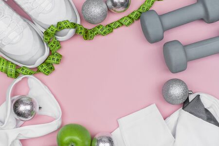Lose weight for the new year, dumbbells, Christmas balls, shape, Apple and ribbon. Diet concept. flat Ley. copy space. Mock upの写真素材