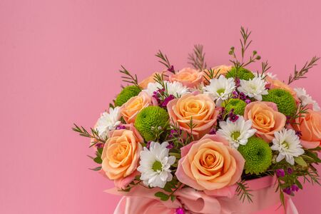 Beautiful bouquet in a pink luxury present box, isolated on pink backgroundの写真素材