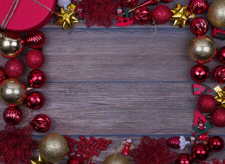 Red and gold Christmas balls on wooden background, top view, mock upの写真素材