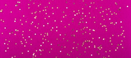 gold stars on pink crimson Magenta background. Festive holiday background. Celebration concept. Top view, flat lay.の写真素材