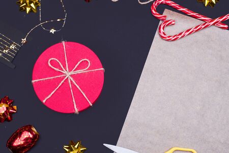 Red round gift box on black background, new year and Christmas gift wrapping . top viewの写真素材