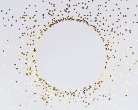 Round frame of festive holiday background with sparkle glitter decoration. Flat lay, top view Christmas or New Year pattern. Mock up.の写真素材