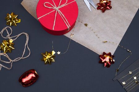 Red round gift box on black background, new year and Christmas gift wrapping . top viewの写真素材