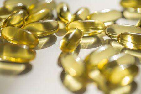 Close up capsules of fish fat oil , omega 3, vitamin Healthy food diet. Nutritional supplementの写真素材