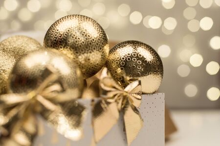 golden christmas ball on golden star bokeh backgroundの写真素材