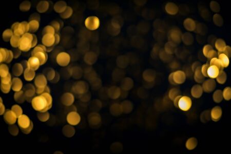 little gold stars on black background Festive holiday background. Celebration concept. Top view, defocused, bluredの写真素材