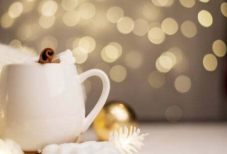 cup of hot cocoa with marshmallows, background with Christmas lights of bokeh. Blurred background.の写真素材