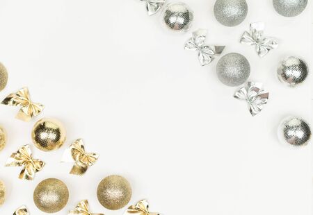 Gold and silver Christmas balls nd bow on white background. White copy space for your text and logo.の写真素材