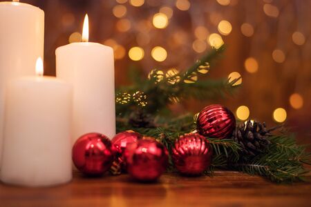 Tree branches, cones, bokeh lights, candles, Christmas balls . Preparation for the New yearの写真素材