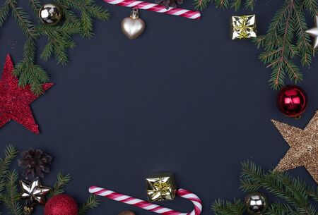 Spruce branches, Christmas balls, candy on a black background, preparing for the New year and Christmas, top view Flat lay, Christmas backgroundの写真素材