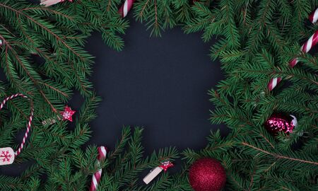 square composition frame of fir branches on black background Christmas background. copyspaceの写真素材