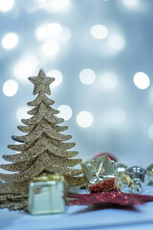 Blue silver Christmas tree and balls on the background of blue bokeh lights on white backgroundの写真素材
