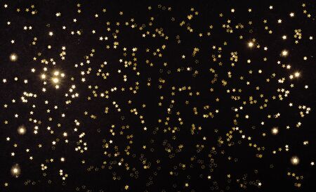 gold stars on dark black background. Festive holiday background. Celebration concept. Top view, flat lay.の写真素材