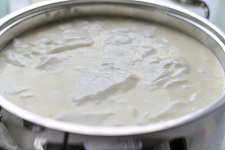 Step cooking cottage cheese, sourdough milk in a saucepan, top view
