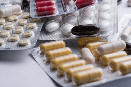 A bunch of blister packs of tablets, pills coronavirus. flu and cold medications. Copy space, Close up, macroの写真素材