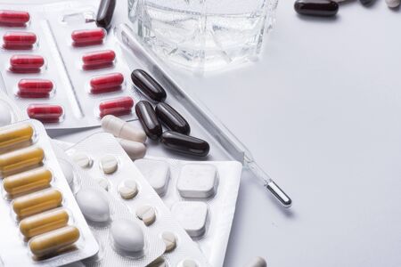 A bunch of blister packs of red and white tablets, pills coronavirus. Medicines. Copy space, Close up, macroの写真素材